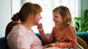 Mamma och dotter hemma i soffan